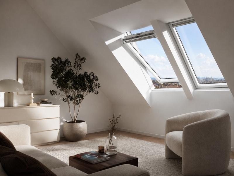 VELUX dakkapel Basis afmetingen met twee grote dakramen in een moderne zolderkamer, veel daglicht en uitzicht naar buiten.